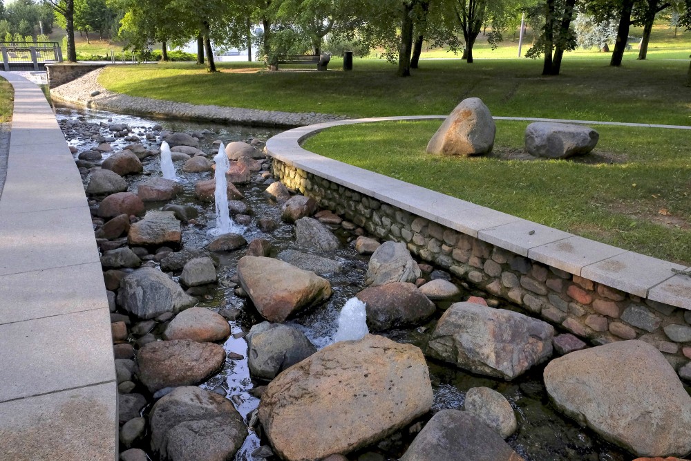 Stone bed stream with water jets in Marijampole Poetry Park