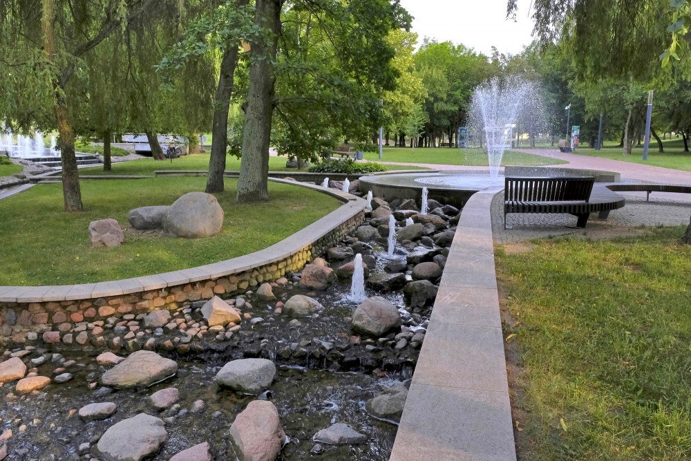 Park stream and tall fountain in Marijampole Poetry Park
