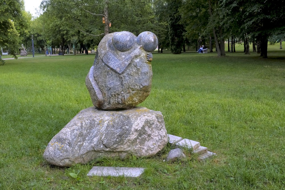 Stone sculpture on a well-kept lawn in Marijampole Poetry Park