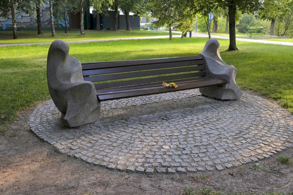 Artistic wooden and stone bench in Marijampole Poetry Park