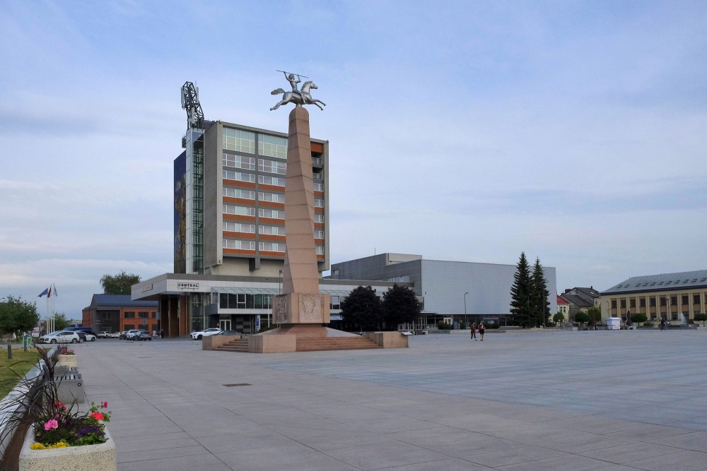 Monument to Nation and Language in Marijampole main square with city background