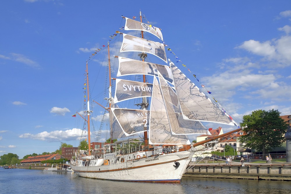 Sailing ship Meridianas with unfurled sails on the Klaipeda river