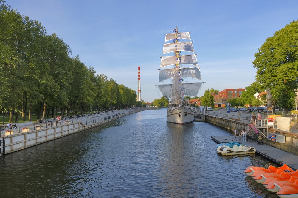 Sailing ship Meridianas by the Dane river promenade on a sunny afternoon